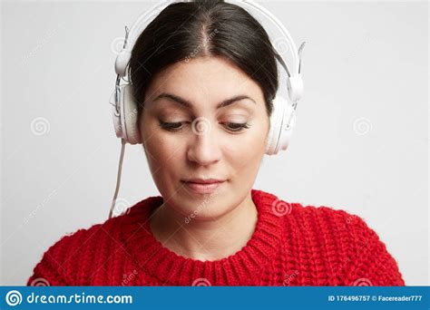 Close Up Portrait Of Young Woman Listening The Music In Her Headphone