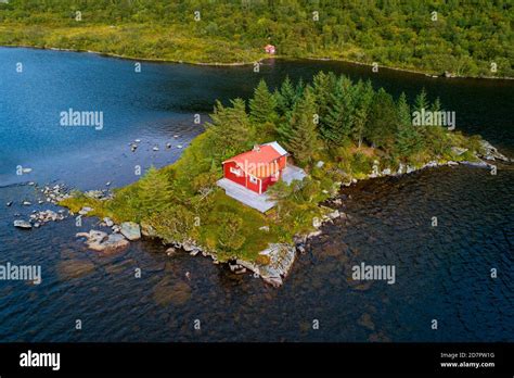 Red Wooden Cabin On A Small Island In A Lake Vestvagoy Nordland