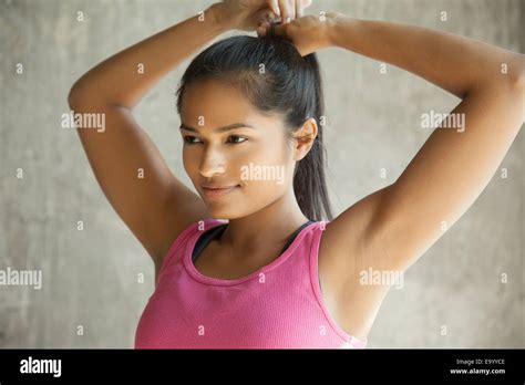Woman Tying Up Hair Stock Photo Alamy