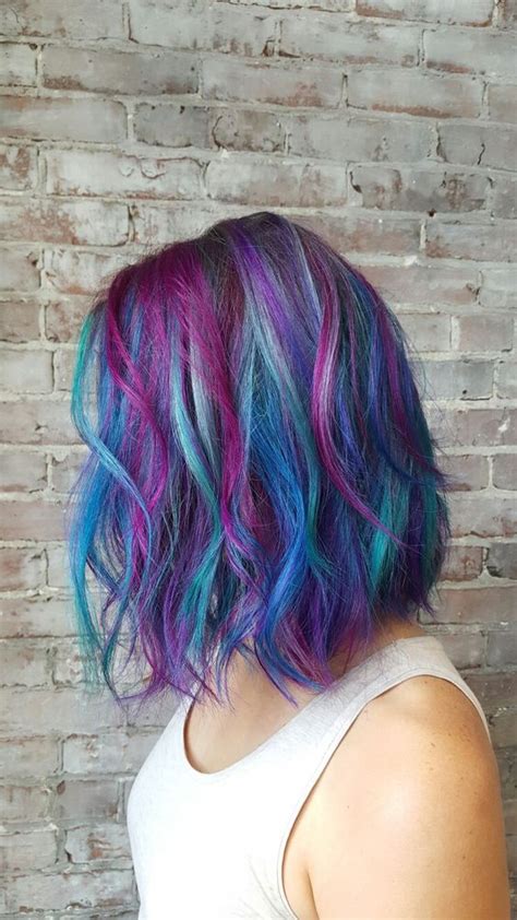 This hairstyle takes bright blue all the way down to the ends where red, yellow and green make a bold pop that looks fresh and simple to maintain. Picture Of blue hair with purple balayage