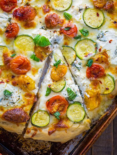 white pizza with tomatoes basil and zucchini baker by nature