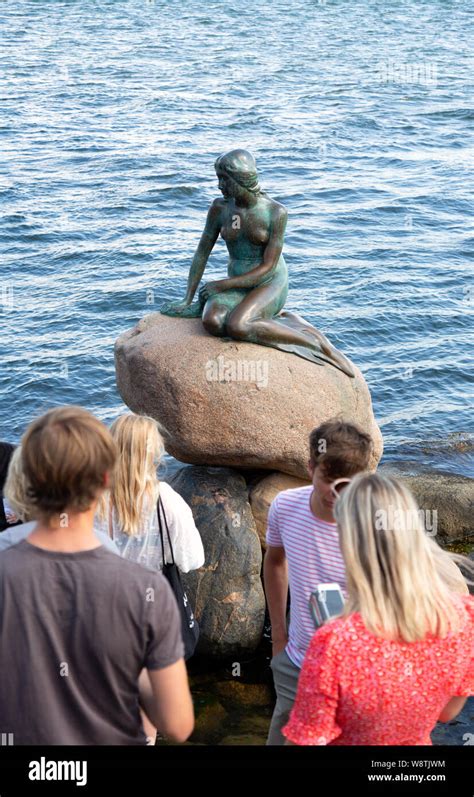 Copenhagen Holiday Tourists Looking At The Little Mermaid Statue