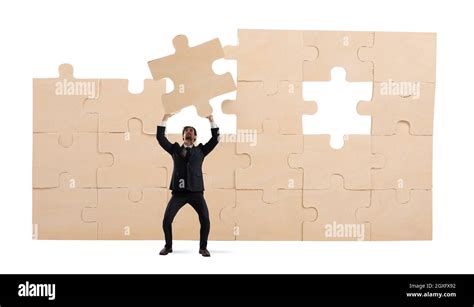 Businessman Holds A Piece Of Puzzle Build The Business Concept Stock