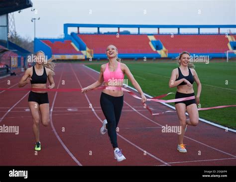 Female Runners Finishing Athletic Race Together Stock Photo Alamy