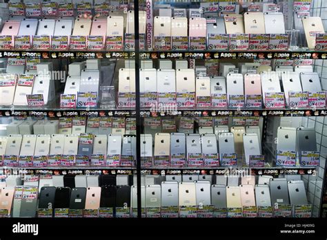 Dozens Of Late Model Iphones On Sale In A Shop Window In Tokyos