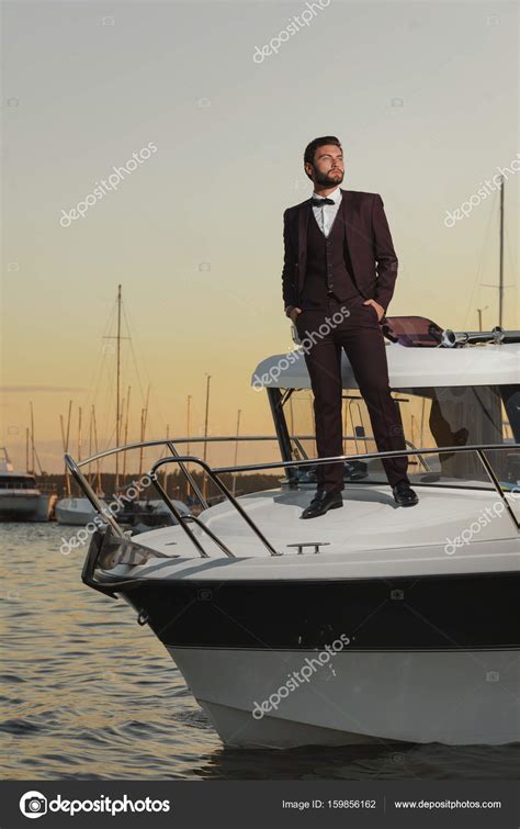 Man Standing On Front Of Luxury Yacht In Sea Stock Photo By ©wanton