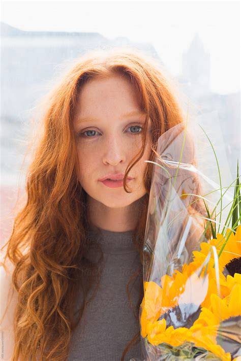 Portrait Of A Beautiful Ginger Hair Woman Holding Sunflowers By Stocksy Contributor Mattia