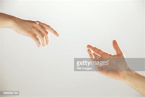 hands reaching towards each other bildbanksbilder getty images