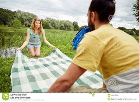 Happy Couple Laying Picnic Blanket At Campsite Stock Image Image Of
