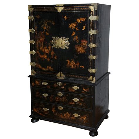 A George I Parcel Gilt Decorated Black Japanned Cabinet On Chest