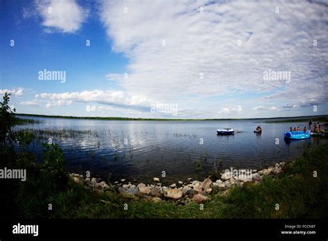 Floating Boats On Water Near Shore Stock Photo Alamy