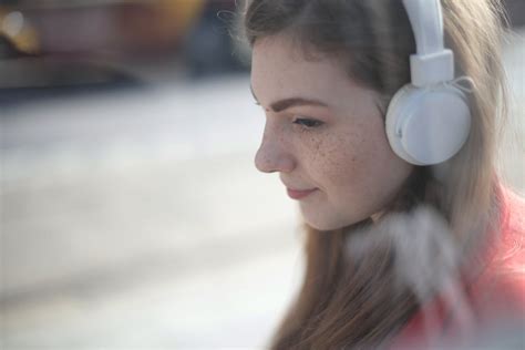 Woman Listening To Music Using White Headphones · Free Stock Photo