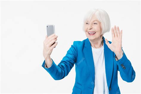premium photo portrait of excited mature lady granny tourist using her smatphone for video