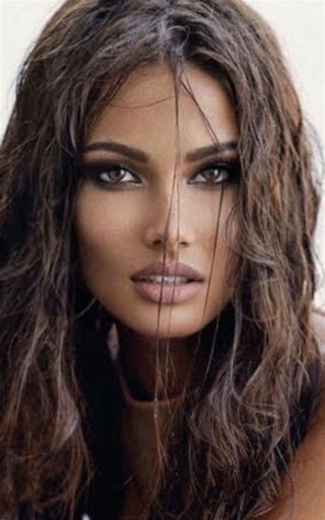 A Woman With Long Brown Hair And Blue Eyes Posing For A Magazine Cover Photo Shoot