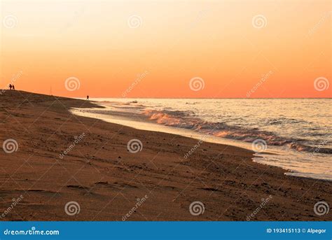 Orange Sky Over A Beautiful Sandy Beach At Sunset Stock Image Image