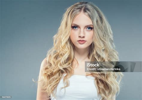 Young Nice Blonde Girl With Long Curly Fly Blonde Hair Woman Healthy Skin And Hairstyle Portrait