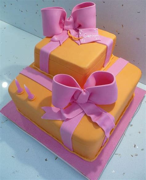 Maybe you would like to learn more about one of these? Two tier orange gift box cake with pink bowties.JPG
