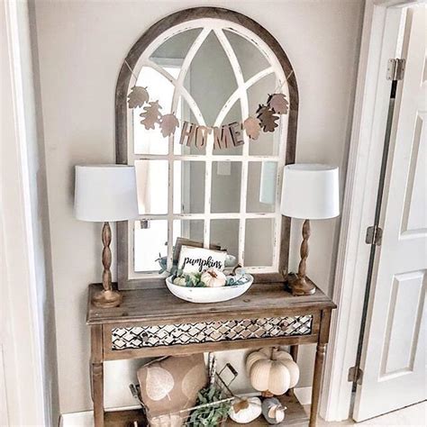The rounded top of a wall mirror provides an elegant detail to functional accessory. Such a gorgeous entryway! @white.oak.shop paired our vail ...