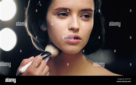 Makeup Artist Applying Powder On Face Of Pretty Model Stock Photo Alamy