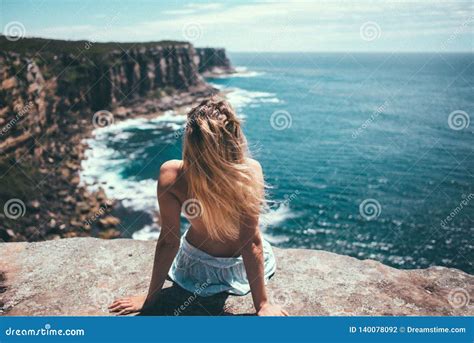 The Girl Sitting On Rocks And Enjoing The Ocean Stock Photo Image Of Vacation Water
