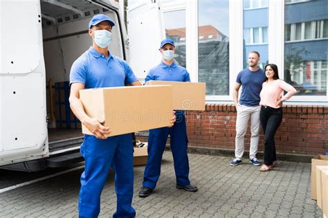 Delivery Men Unloading Boxes Stock Photo Image Of Delivering