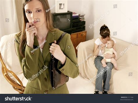 Working Mother Leaving A Baby At Home With A Babysitter Stock Photo