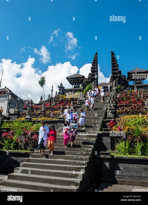 Balinese Believers In Traditional Clothing Go Down Stairs Split Gate