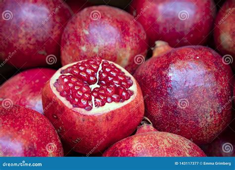 Open Fruit Of Ripe Pomegranate With Burgundy Grains Close Up In A Pile