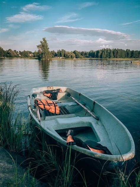 Boat Floating On Calm River · Free Stock Photo
