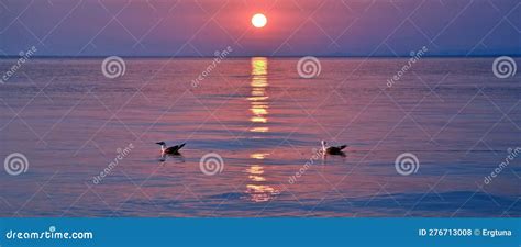 A Breathtaking Sunset Paints The Sky And Ocean In Vibrant Hues At