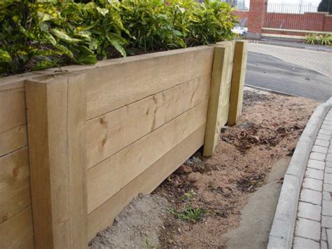 The width of the foundation should be 250mm wider than the wall you intend to build and the wall should be built in the centre of the foundations making sure that the distances a and b are the same. Railway Sleepers