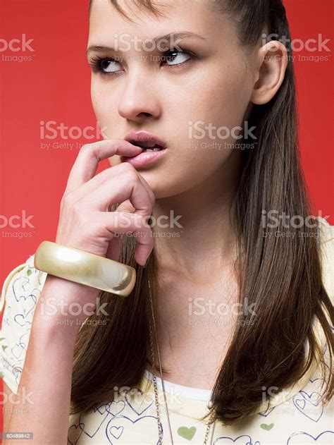 A Teenage Girl Biting Her Finger Stock Photo Download Image Now