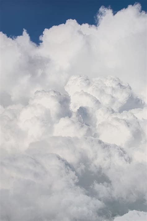 Fluffy Clouds Cumulonimbus At High Altitude Over Deep Blue Sky Heaven