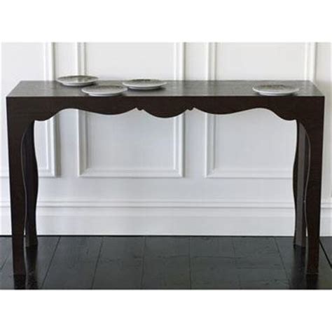 A modern console table gives an important first impression for guests. Black Silhouette Scalloped Frame Console Table