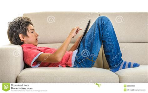 Smiling woman lying on the sofa. Boy With Tablet Pc Lying On The Sofa Stock Photo - Image ...