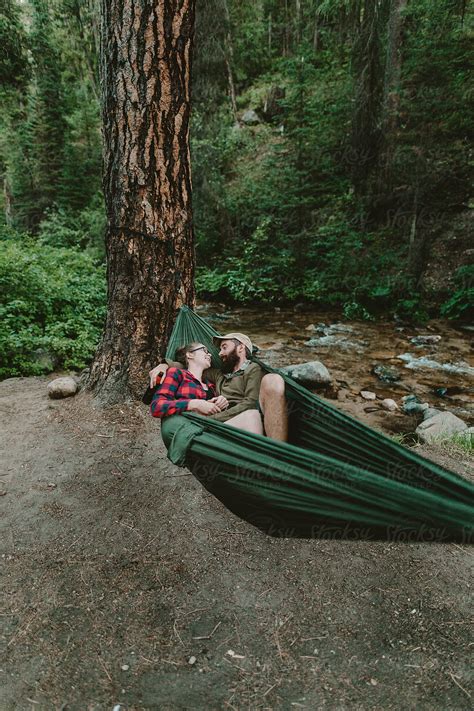 cute couple lounging in hammock by stocksy contributor leah flores stocksy