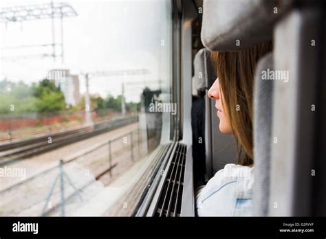 A Young Girl Sitting At A Window Seat Hi Res Stock Photography And