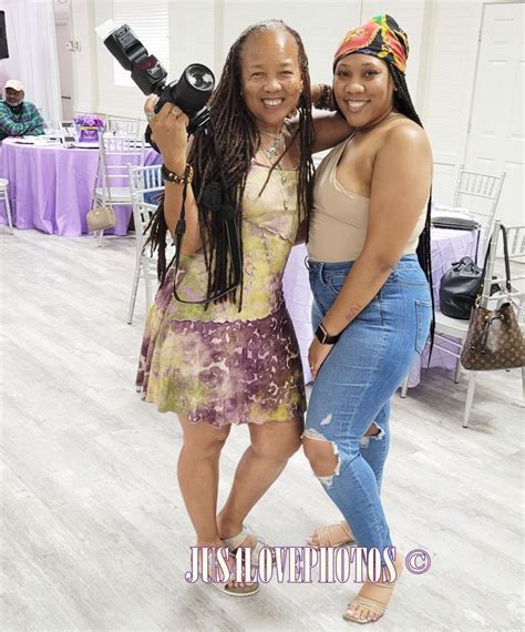 Two Women Standing Next To Each Other In A Room