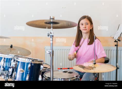 Little Caucasian Girl Drummer Playing The Elettronic Drum Kit And Shuoting Teen Girls Are