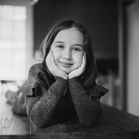 Black And White Portrait Of A Pretty Young Girl Laying On A Kitchen