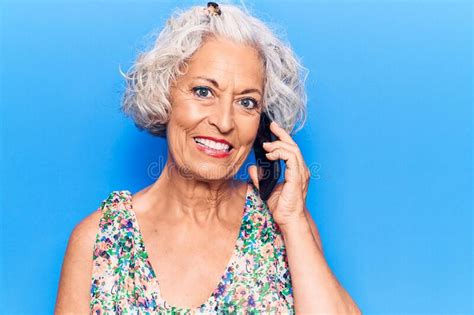 Senior Grey Haired Woman Having Conversation Talking On The Smartphone