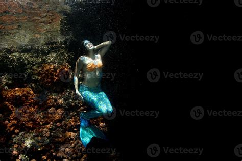 Beautiful Mermaid Swimming Underwater In The Deep Blue Sea 12229619