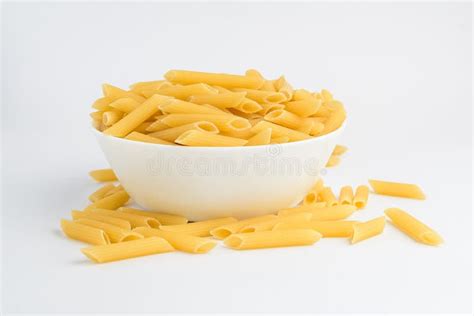 Dried Penne Italian Pasta In A Round Bowl Ready To Be Cooked Isolated