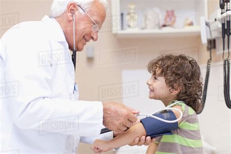 Doctor Examining Boy In Office Stock Photo Dissolve