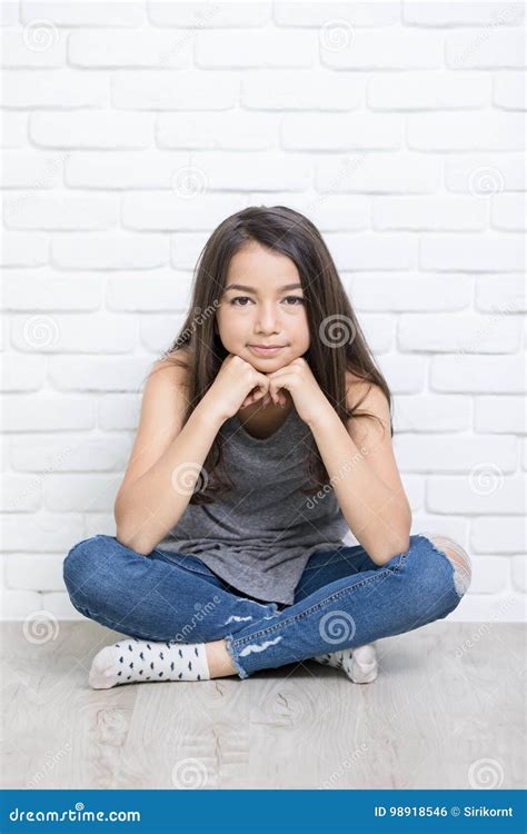 Portrait Of A Beautiful Happy Smiling Girl Sitting On The Floor Stock