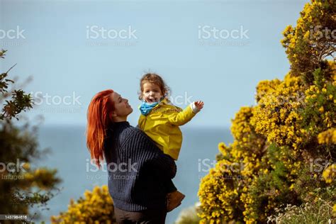 Young Mother Holding Her Baby Girl In Her Arms They Are The Ocean Stock