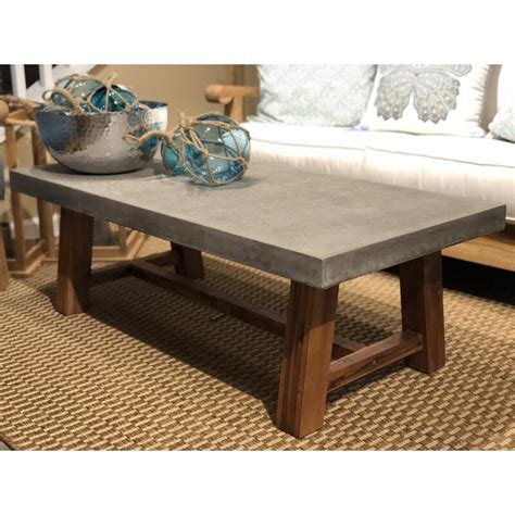 Decorating with concrete can be a great way to add modern touches to a classic home, and building a concrete coffee table is an easy way to incorporate concrete into the design of a room. Foundry Select Colegrove Stone/Concrete Coffee Table | Wayfair