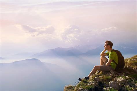 Man Sitting On Top Of Mountain Achievement Or Opportunity Conce