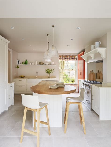 A White Harvey Jones Shaker Kitchen With Island Pendant Lights And