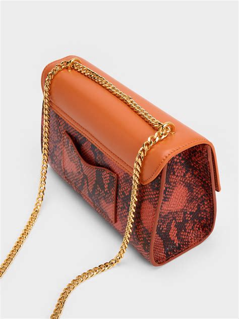 Orange Snake Print Metallic Accent Clutch Charles And Keith Mo